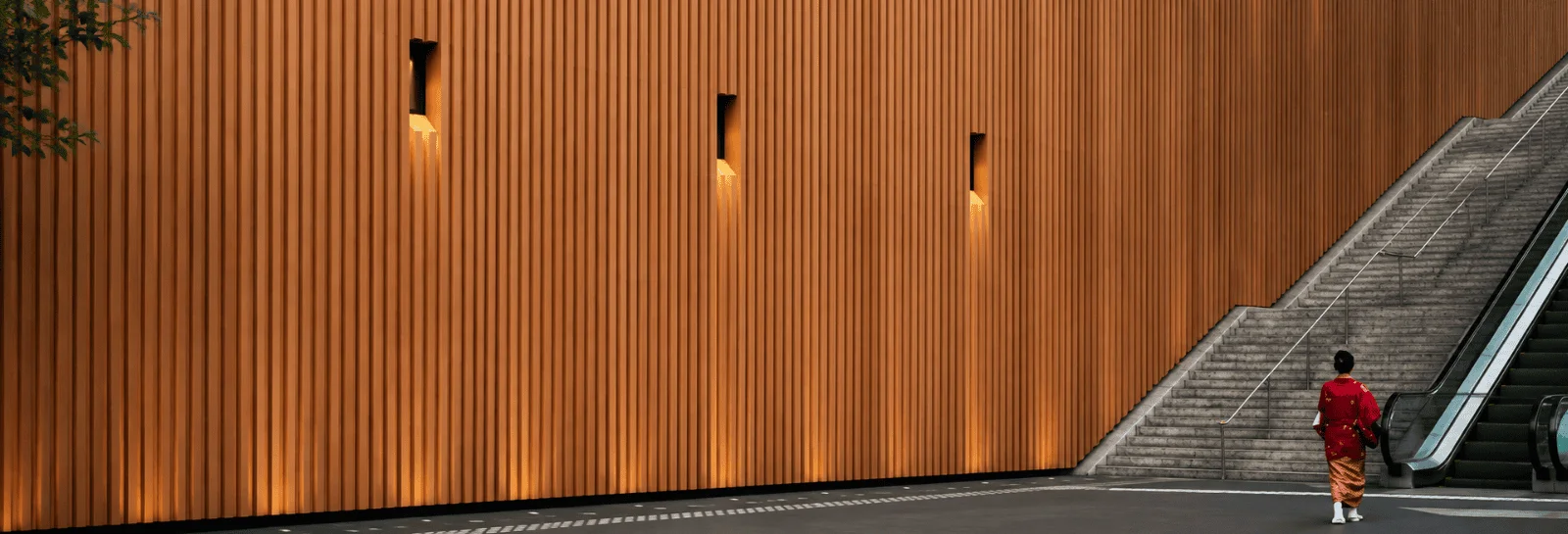 Exterior HPL facade panels with vertical timber slats on a modern commercial building wall next to outdoor concrete stairs and an escalator.